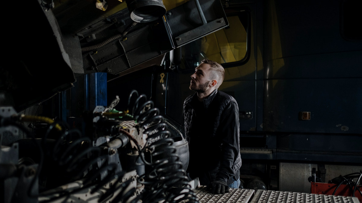 Driver inspecting his tractor in the shop — revoked ELD list September 2026 replacement deadline